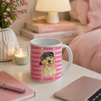 A white ceramic mug with a pink background pattern of the word 'JERRY' and a central illustration of a golden retriever wearing a black cap, styled on a bedside table in a cozy bedroom setting.