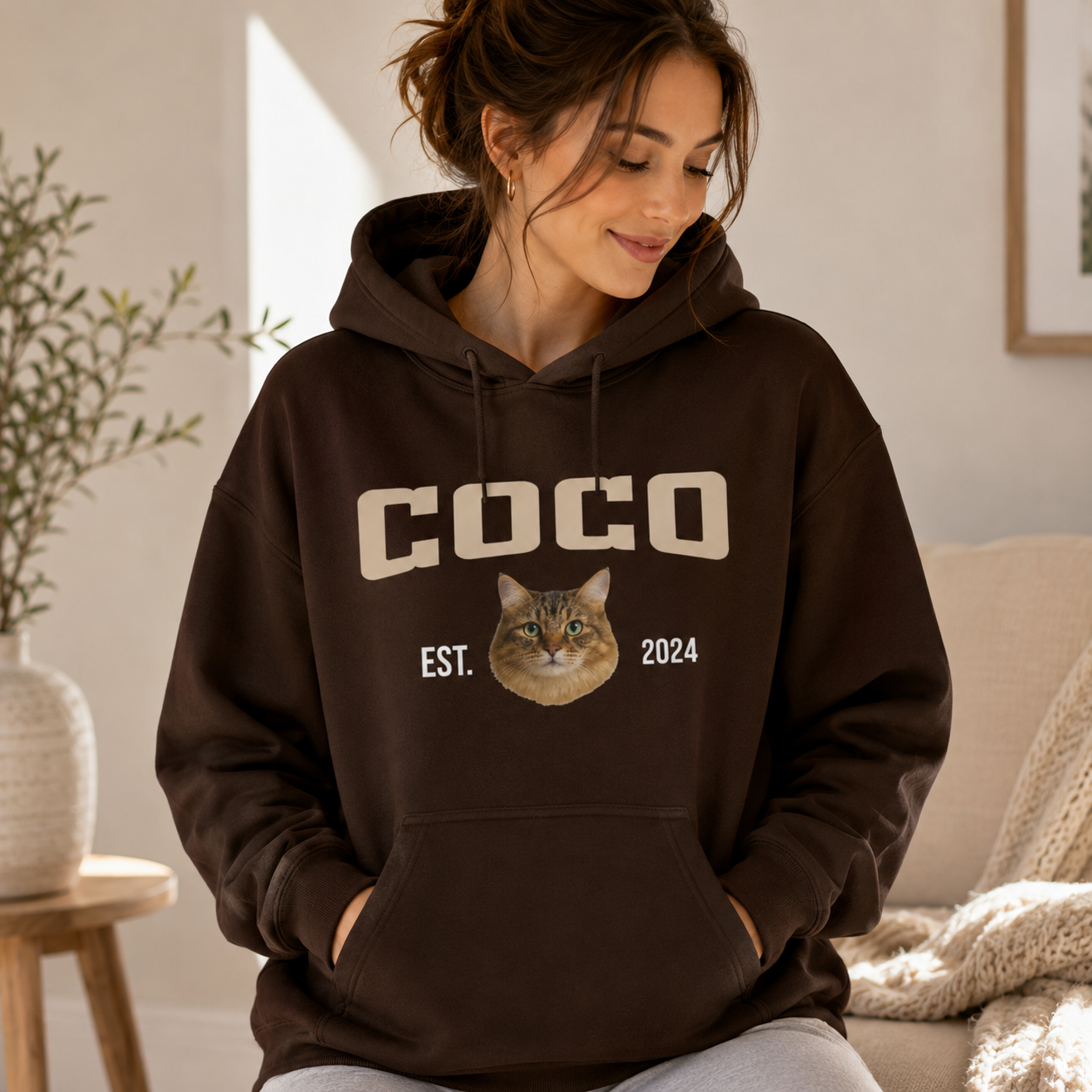 Woman wearing a personalized cat photo hoodie with custom pet name and year