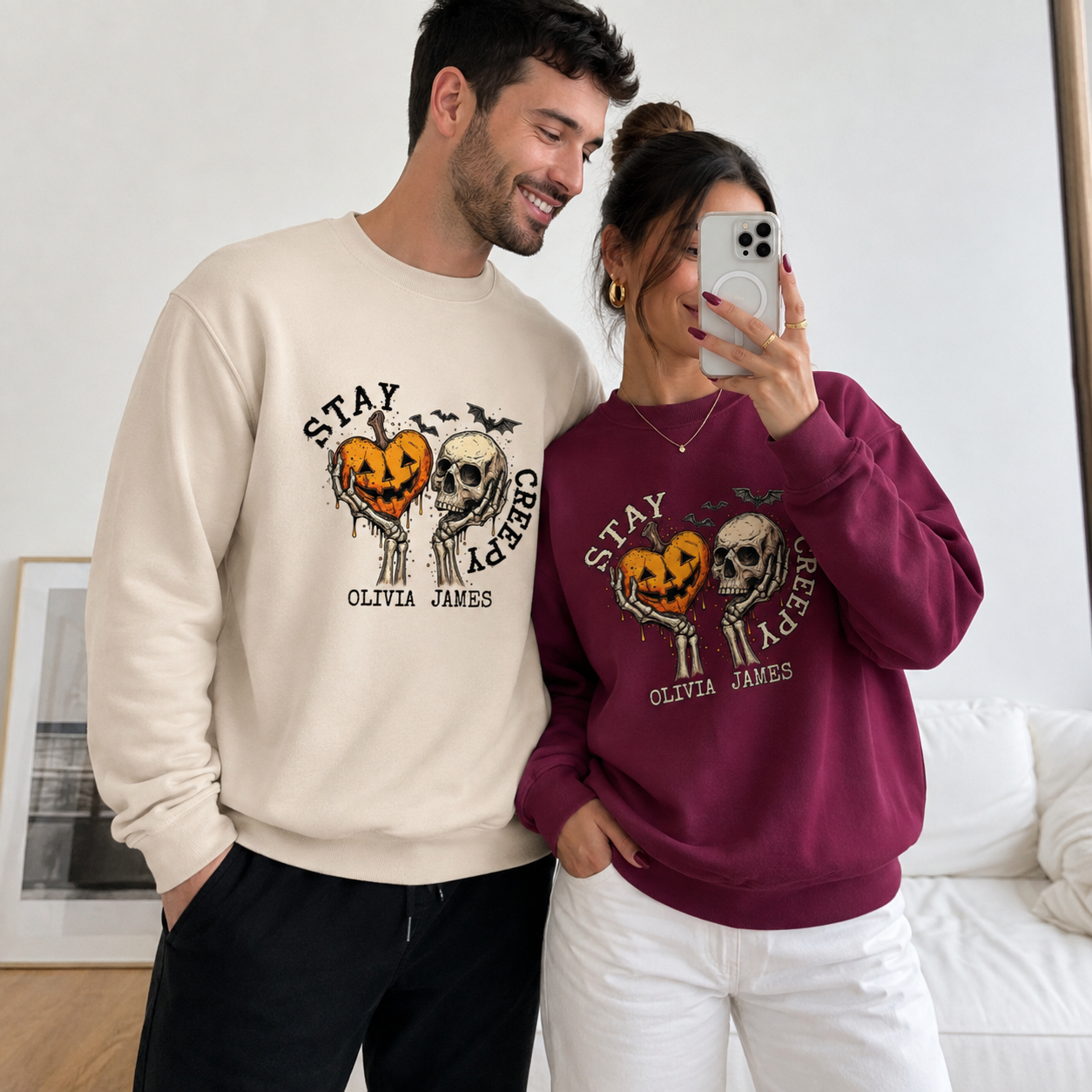 Couple wearing matching personalized Halloween sweatshirts with Stay Creepy design and custom names